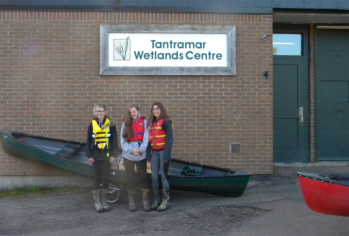 Students in front of canoes