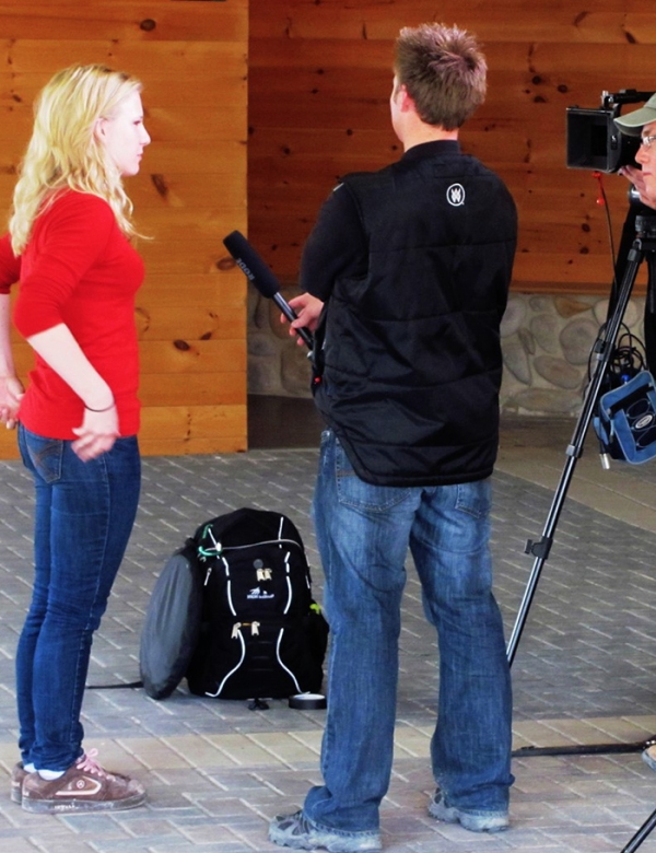 Woman being interview by TV reporter